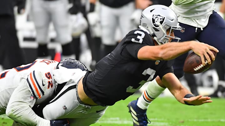 Oct 10, 2021; Paradise, Nevada, USA; Las Vegas Raiders quarterback Nathan Peterman (3) lunges for extra yardage while being tackled by Chicago Bears outside linebacker Khalil Mack (52) during a game at Allegiant Stadium. Mandatory Credit: Stephen R. Sylvanie-USA TODAY Sports