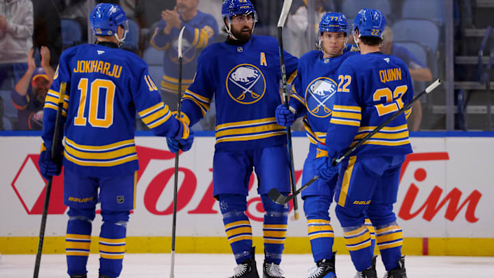 Sep 21, 2024; Buffalo, New York, USA;  Buffalo Sabres right wing JJ Peterka (77) celebrates his goal with teammates during the first period against the Pittsburgh Penguins at KeyBank Center. Mandatory Credit: Timothy T. Ludwig-Imagn Images