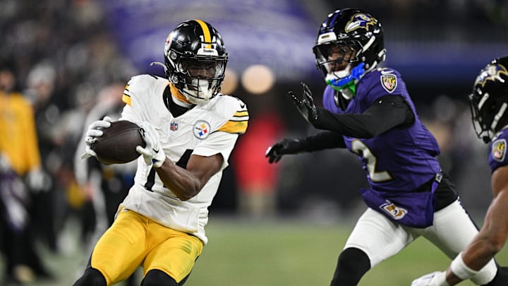 Jan 11, 2025; Baltimore, Maryland, USA; Pittsburgh Steelers wide receiver George Pickens (14) makes a catch against Baltimore Ravens cornerback Nate Wiggins (2) in the third quarter in an AFC wild card game at M&T Bank Stadium. Mandatory Credit: Tommy Gilligan-Imagn Images