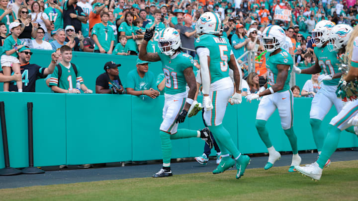 Miami Dolphins wide receiver Theo Wease Jr. (81) celebrates with teammates after scoring a touchdown during the first quarter against the Tampa Bay Buccaneers at Hard Rock Stadium. 