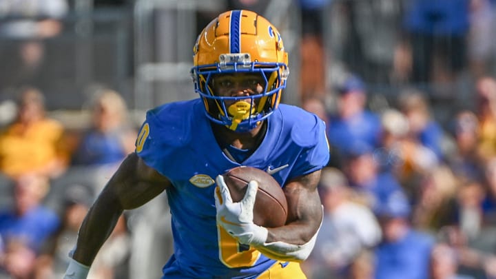 Sep 14, 2024; Pittsburgh, Pennsylvania, USA; Pittsburgh Panthers running back Desmond Reid gains yardage against the West Virginia Mountaineers during the first quarter at Acrisure Stadium. Mandatory Credit: Barry Reeger-Imagn Images