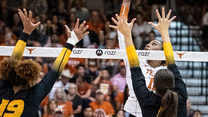 Texas Longhorns middle blocker Marianna Singletary (11) hits the ball over the net during the Longhorns' match-up with the Missouri Tigers at the Gregory Gym in Austin, Nov. 1, 2024.