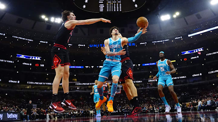 Chicago Bulls guard Josh Giddey (3) defends Charlotte Hornets guard LaMelo Ball (1) during the first half at United Center. Mandatory Credit: David Banks-Imagn Images