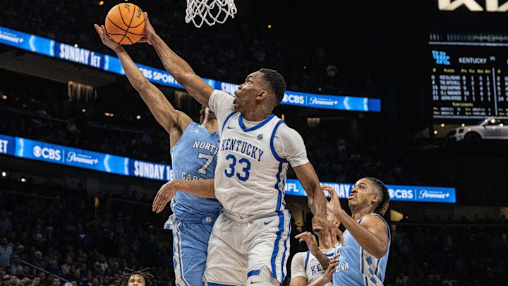 Dec 16, 2023; Atlanta, Georgia, USA; Kentucky Wildcats forward Ugonna Onyenso (33) blocks the shot by North Carolina Tar Heels guard Seth Trimble (7) during the second half at State Farm Arena. Mandatory Credit: Jordan Godfree-Imagn Images