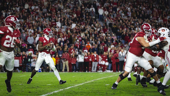 Nov 30, 2024; Tuscaloosa, Alabama, USA; Alabama Crimson Tide quarterback Jalen Milroe (4) drops back to pass against the Auburn Tigers during the third quarter at Bryant-Denny Stadium. Mandatory Credit: Will McLelland-Imagn Images