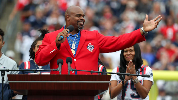 Sep 25, 2022; Foxborough, Massachusetts, USA; New England Patriots Hall of Famer Vince Wilfork reacts during a halftime celebration at Gillette Stadium during a game against the Baltimore Ravens. Mandatory Credit: Paul Rutherford-Imagn Images
