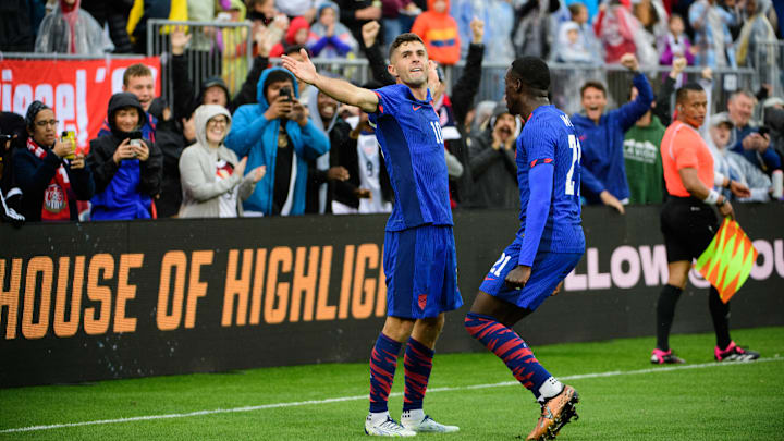 Christian Pulisic and Tim Weah celebrate a USMNT goal during a friendly match against Germany.