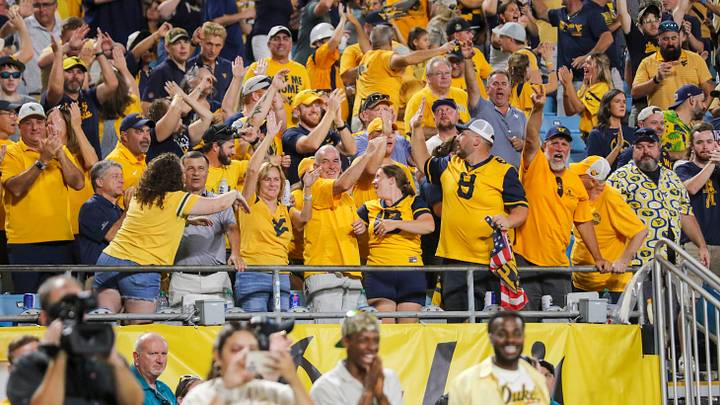 Sep 19, 2026; Charlotte, North Carolina, USA; West Virginia Mountaineers fans cheer after a touchdown during the second quarter against the Virginia Cavaliers at Bank of America Stadium. Mandatory Credit: Ben Queen-Imagn Images Sep 19, 2026; Charlotte, North Carolina, USA; West Virginia Mountaineers fans cheer after a touchdown during the second quarter against the Virginia Cavaliers at Bank of America Stadium. Mandatory Credit: Ben Queen-Imagn Images