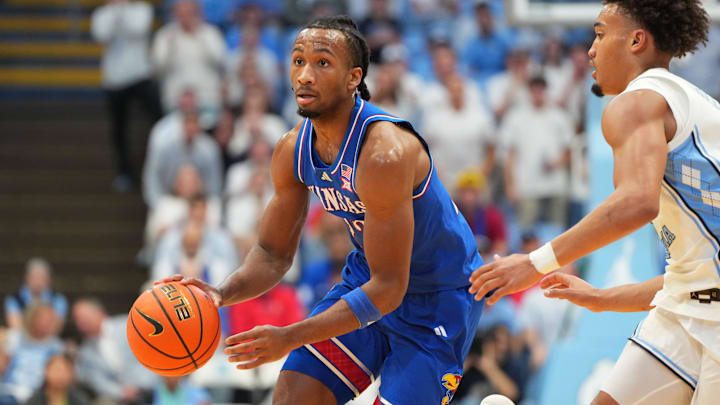 Nov 7, 2025; Chapel Hill, North Carolina, USA; Kansas Jayhawks guard Darryn Peterson (22) dribbles as North Carolina Tar Heels guard Seth Trimble (7) defends in the first half at Dean E. Smith Center. Mandatory Credit: Bob Donnan-Imagn Images