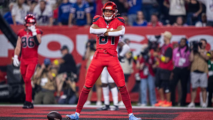 Jayden Higgins celebrates in the end zone after a Houston Texans touchdown