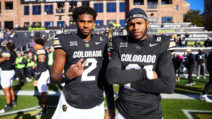 Nov 29, 2024; Boulder, Colorado, USA; Colorado Buffaloes quarterback Shedeur Sanders (2) and safety Shilo Sanders (21) pose for a photo before the game against the Oklahoma State Cowboys at Folsom Field. Mandatory Credit: Ron Chenoy-Imagn Images