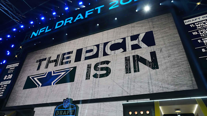 The Dallas Cowboys logo is projected on the video board during the NFL Draft at Lambeau Field. 