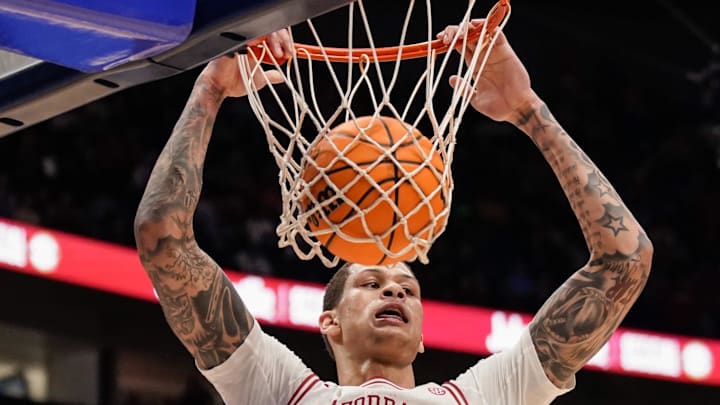 Arkansas forward Trevon Brazile (7) dunks during the second half of the SEC tournament championship game against Vanderbilt at Bridgestone Arena in Nashville, Tenn., Sunday, March 15, 2026.