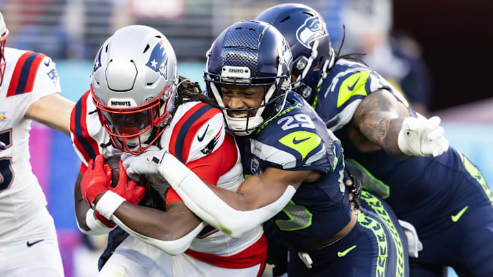 Feb 8, 2026; Santa Clara, CA, USA; Seattle Seahawks cornerback Josh Jobe (29) tackles New England Patriots running back Rhamondre Stevenson (38) during the second quarter in Super Bowl LX at Levi's Stadium. Mandatory Credit: Mark J. Rebilas-Imagn Images