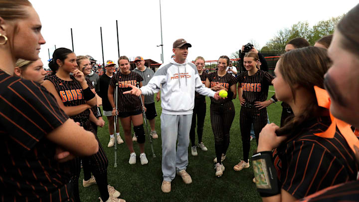 Kaukauna High School softball head coach Tim Roehrig congratulates his players after a victory over Kimberly. The program's 100th consecutive win came on Friday, May 10, 2024, 