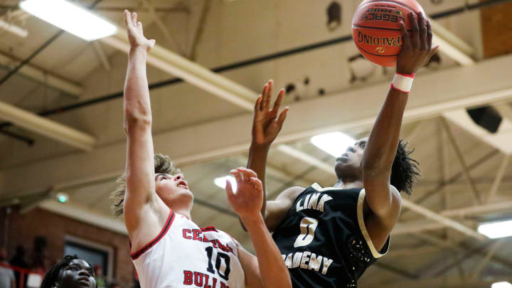Link Academy's Tre Johnson goes up for a field goal attempt as the Lions took on the Central Bulldogs in The Pit at Central High School on Tuesday, Nov. 28, 2023. Link Academy's Tre Johnson goes up for a field goal attempt as the Lions took on the Central Bulldogs in The Pit at Central High School on Tuesday, Nov. 28, 2023.