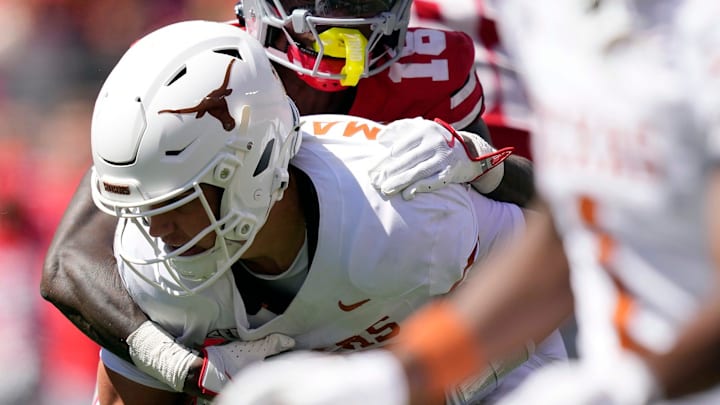 Ohio State Buckeyes safety Jaylen McClain (18) brings down Texas Longhorns quarterback Arch Manning (16) on Saturday. Ohio State Buckeyes safety Jaylen McClain (18) brings down Texas Longhorns quarterback Arch Manning (16) on Saturday.