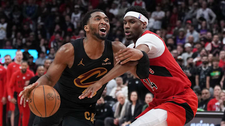 May 1, 2026; Toronto, Ontario, CAN; Cleveland Cavaliers guard Donovan Mitchell (45) controls the ball as Toronto Raptors guard Ja kobe Walter (14) tries to defend during the fourth quarter in game six of the first round of the 2026 NBA Playoffs at Scotiabank Arena. Mandatory Credit: Nick Turchiaro-Imagn Images