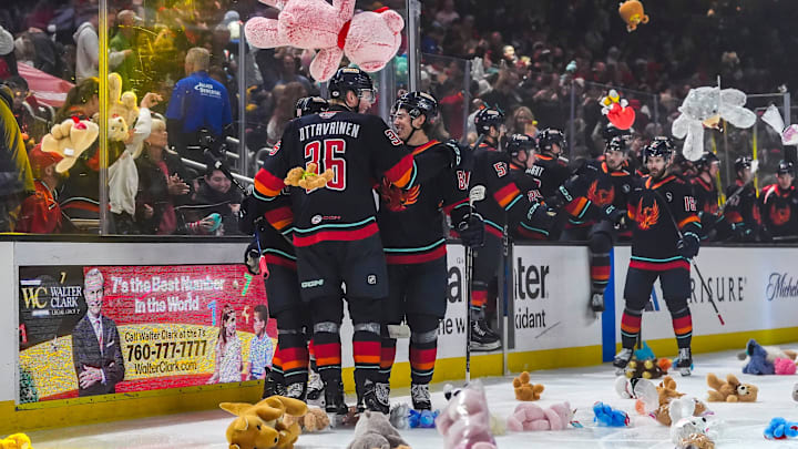 Coachella Valley Firebirds players celebrate a goal by forward Luke Henman triggering the teddy bear toss during the first period of their game at Acrisure Arena in Palm Desert, Calif., Saturday, Dec. 28, 2024.