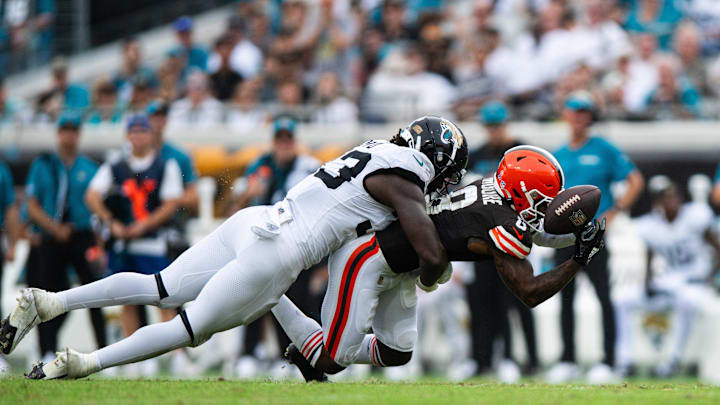 Sep 15, 2024; Jacksonville, Florida, USA; Jacksonville Jaguars linebacker Devin Lloyd (33) breaks up a pass against the Cleveland Browns wide receiver Elijah Moore (8) in the third quarter at EverBank Stadium. Mandatory Credit: Jeremy Reper-Imagn Images