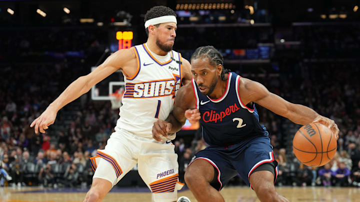 Jan 27, 2025; Phoenix, Arizona, USA; Phoenix Suns guard Devin Booker (1) guards LA Clippers forward Kawhi Leonard (2) during the second half at Footprint Center. Mandatory Credit: Joe Camporeale-Imagn Images