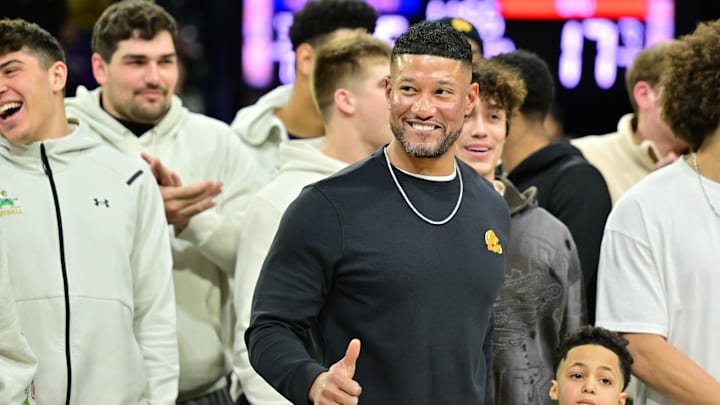 Feb 19, 2025; South Bend, Indiana, USA; Notre Dame head football coach Marcus Freeman and team are honored in the first half of the game between the Notre Dame Fighting Irish and the SMU Mustangs at the Purcell Pavilion. Mandatory Credit: Matt Cashore-Imagn Images Feb 19, 2025; South Bend, Indiana, USA; Notre Dame head football coach Marcus Freeman and team are honored in the first half of the game between the Notre Dame Fighting Irish and the SMU Mustangs at the Purcell Pavilion. Mandatory Credit: Matt Cashore-Imagn Images