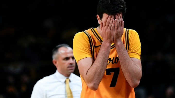 Iowa Hawkeyes forward Alvaro Folgueiras and head coach Ben McCollum Iowa Hawkeyes forward Alvaro Folgueiras and head coach Ben McCollum