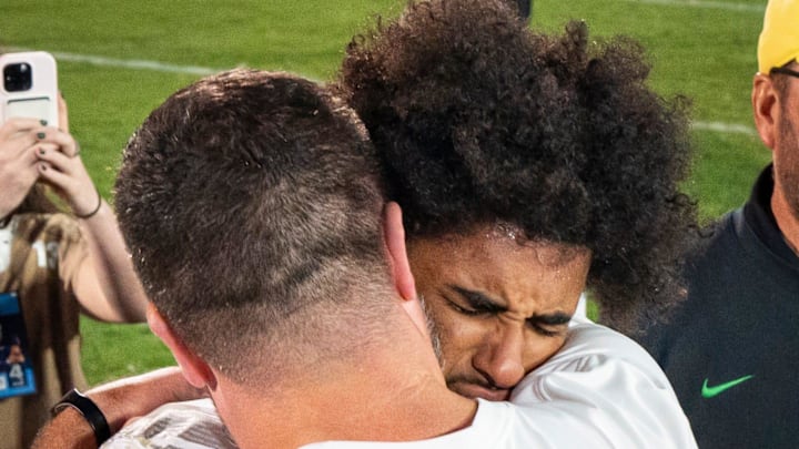 Dan Lanning and Dante Moore share an emotional moment after the Ducks' double overtime win at Penn State. Projected as the second quarterback taken in the NFL draft, Moore passed up a big payday to return for his redshirt junior season.