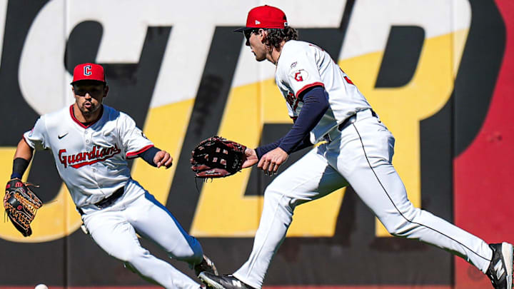 Cleveland Guardians left fielder Steven Kwan (38), left, and center fielder Chase DeLauter (34) try to grab the ball after Chase DeLauter’s error against Detroit Tigers during the first inning of Game 2 of AL wild-card series at Progressive Field in Cleveland, Ohio on Wednesday, Oct. 1, 2025.