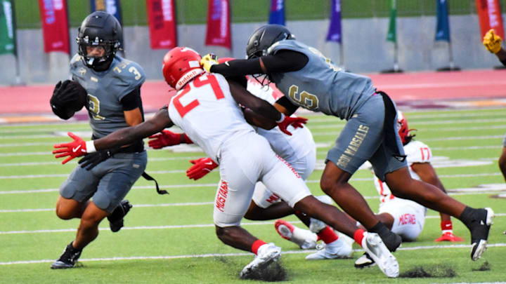 Dallas South Oak Cliff's Torrin Teague, left, tries to avoid a tackle against Galena Park North Shore during a game Friday, Aug. 29 in Dallas. Dallas South Oak Cliff's Torrin Teague, left, tries to avoid a tackle against Galena Park North Shore during a game Friday, Aug. 29 in Dallas.