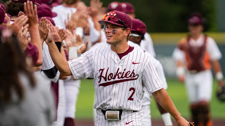Sam Tackett (2) leads the Hokies down the line in high fives after a victory.