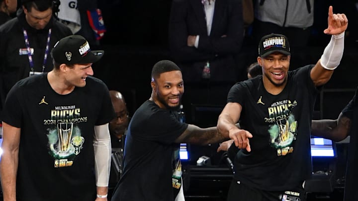 Dec 17, 2024; Las Vegas, Nevada, USA; (Left to right) Milwaukee Bucks center Brook Lopez (11), guard Damian Lillard (0) and forward Giannis Antetokounmpo (34) celebrate after winning the Emirates NBA Cup championship game against the Oklahoma City Thunder at T-Mobile Arena. Mandatory Credit: Candice Ward-Imagn Images