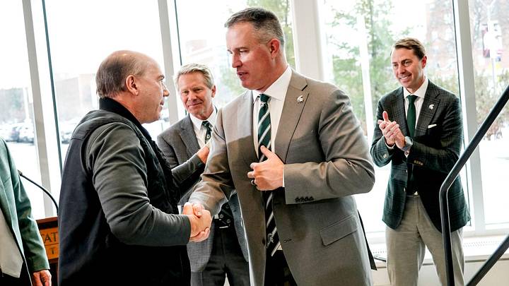 Michigan State football coach Pat Fitzgerald, right, shakes hands with Greg Williams, left, during Fitzgerald's introductory press conference on Tuesday, Dec. 2, 2025, at the Tom Izzo Football Building in East Lansing. Michigan State football coach Pat Fitzgerald, right, shakes hands with Greg Williams, left, during Fitzgerald's introductory press conference on Tuesday, Dec. 2, 2025, at the Tom Izzo Football Building in East Lansing.