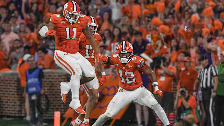 Sep 16, 2023; Clemson, South Carolina; Clemson defensive lineman T.J. Parker (12) reacts with defensive lineman Peter Woods (11) after sacking Florida Atlantic quarterback Daniel Richardson (10) during the second quarter against Florida Atlantic at Memorial Stadium. Sep 16, 2023; Clemson, South Carolina; Clemson defensive lineman T.J. Parker (12) reacts with defensive lineman Peter Woods (11) after sacking Florida Atlantic quarterback Daniel Richardson (10) during the second quarter against Florida Atlantic at Memorial Stadium.