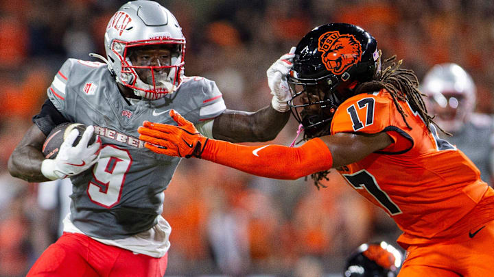 UNLV Rebels running back Jai'Den Thomas (9) stiff arms Oregon State Beavers defensive back Skyler Thomas (17) during an NCAA football game against UNLV