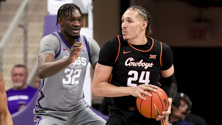 Feb 12, 2025; Fort Worth, Texas, USA;  Oklahoma State Cowboys forward Patrick Suemnick (24) controls the ball as TCU Horned Frogs center Malick Diallo (32) defends during the first half at Ed and Rae Schollmaier Arena. Mandatory Credit: Kevin Jairaj-Imagn Images