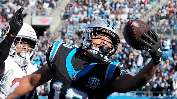 Dec 22, 2024; Charlotte, North Carolina, USA; Carolina Panthers wide receiver Jalen Coker (18) attempts to catch the ball in the end zone as Arizona Cardinals safety Jalen Thompson (34) defends in the first quarter at Bank of America Stadium. Mandatory Credit: Bob Donnan-Imagn Images Dec 22, 2024; Charlotte, North Carolina, USA; Carolina Panthers wide receiver Jalen Coker (18) attempts to catch the ball in the end zone as Arizona Cardinals safety Jalen Thompson (34) defends in the first quarter at Bank of America Stadium. Mandatory Credit: Bob Donnan-Imagn Images