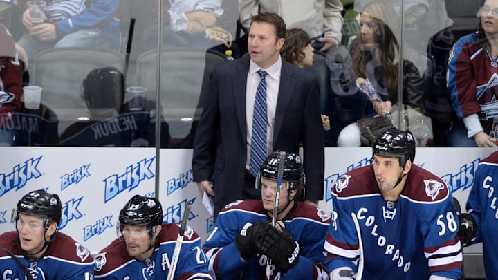 April 15 2013; Denver, CO, USA; Colorado Avalanche head coach Joe Sacco (center) on his bench with center Brad Malone (42) and right wing Milan Hejduk (23) and left wing Jamie McGinn (11) and left wing Patrick Bordeleau (58) during the first period of the game against the Edmonton Oilers at the Pepsi Center. Mandatory Credit: Ron Chenoy-Imagn Images