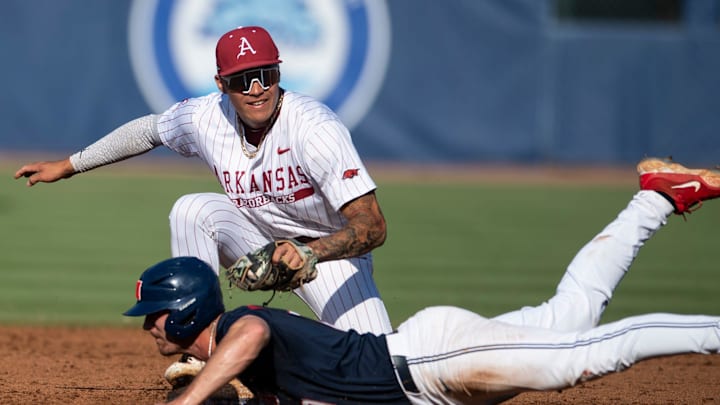 Arkansas Razorbacks' Wehiwa Aloy (9) tags out Ole Miss Rebels' Judd Utermark (27) at second base as Arkansas Razorbacks take on Ole Miss Rebels during the SEC baseball tournament at Hoover Met in Birmingham, Ala., on Friday, May 23, 2025. Ole Miss Rebels defeated Arkansas Razorbacks 5-2.