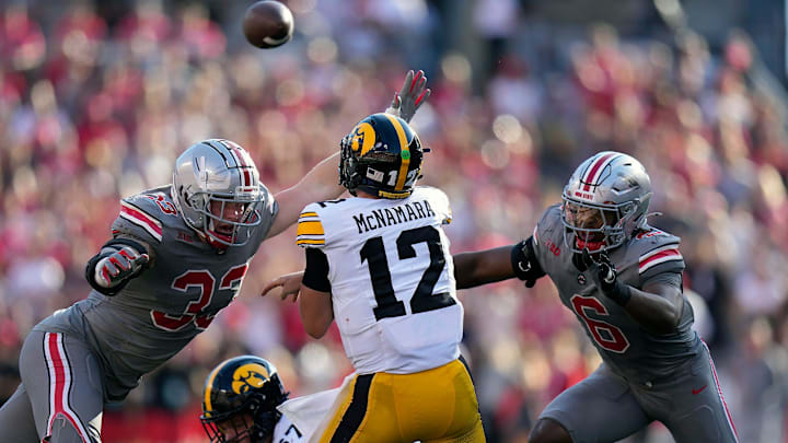 Oct 5, 2024; Columbus, OH, USA; Iowa Hawkeyes quarterback Cade McNamara (12) gets a pass off against Ohio State Buckeyes defensive end Jack Sawyer (33) and Ohio State Buckeyes safety Sonny Styles (6) in the second quarter during the NCAA football game at Ohio Stadium. Oct 5, 2024; Columbus, OH, USA; Iowa Hawkeyes quarterback Cade McNamara (12) gets a pass off against Ohio State Buckeyes defensive end Jack Sawyer (33) and Ohio State Buckeyes safety Sonny Styles (6) in the second quarter during the NCAA football game at Ohio Stadium.