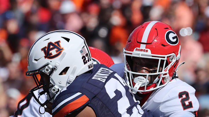Sep 30, 2023; Auburn, Alabama, USA; Georgia Bulldogs linebacker Smael Mondon Jr. (2) tackles Auburn Tigers running back Jarquez Hunter (27) during the first quarter at Jordan-Hare Stadium. Mandatory Credit: John Reed-Imagn Images