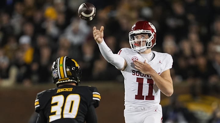 Nov 9, 2024; Columbia, Missouri, USA; Oklahoma Sooners wide receiver Jayden Gibson (1) throws a pass against Missouri Tigers linebacker Chuck Hicks (30) during the first half at Faurot Field at Memorial Stadium. Mandatory Credit: Jay Biggerstaff-Imagn Images Nov 9, 2024; Columbia, Missouri, USA; Oklahoma Sooners wide receiver Jayden Gibson (1) throws a pass against Missouri Tigers linebacker Chuck Hicks (30) during the first half at Faurot Field at Memorial Stadium. Mandatory Credit: Jay Biggerstaff-Imagn Images