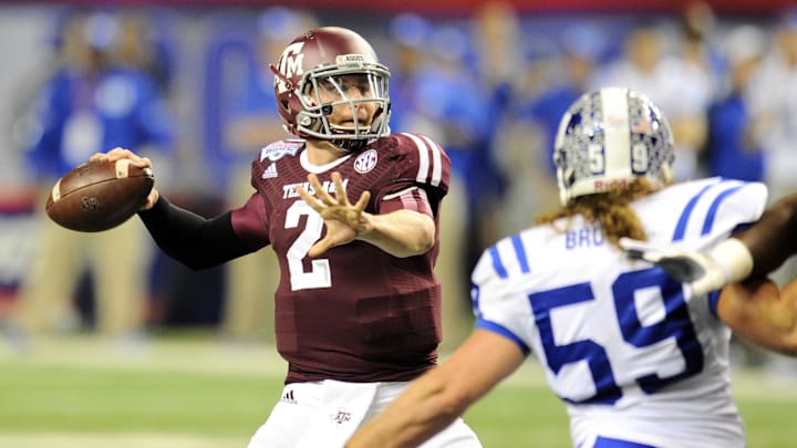 Texas A&M Aggies quarterback Johnny Manziel (2) throws the ball pressured by Duke Blue Devils linebacker Kelby Brown (59) during the second quarter in the 2013 Chick-fil-a Bowl at the Georgia Dome.