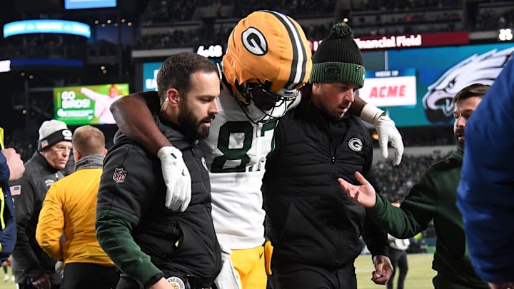 Jan 12, 2025; Philadelphia, Pennsylvania, USA; Green Bay Packers wide receiver Romeo Doubs (87) is helped off the field after being injured against the Philadelphia Eagles in an NFC wild card game at Lincoln Financial Field. Mandatory Credit: Eric Hartline-Imagn Images