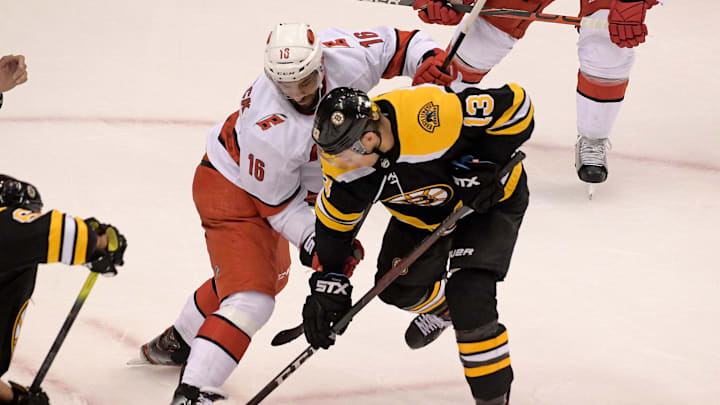 Aug 13, 2020; Toronto, Ontario, CAN; Boston Bruins center Charlie Coyle (13) battles Carolina Hurricanes center Vincent Trocheck (16) for the puck during the first period in game two of the first round of the 2020 Stanley Cup Playoffs at Scotiabank Arena. Mandatory Credit: Dan Hamilton-Imagn Images