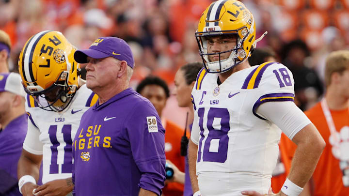 Aug 30, 2025; Clemson, South Carolina, USA; LSU Tigers head coach Brian Kelly and quarterback Garrett Nussmeier (18) look on during warmups before the game against the Clemson Tigers at Memorial Stadium. Mandatory Credit: Ken Ruinard-USA TODAY Network via Imagn Images Aug 30, 2025; Clemson, South Carolina, USA; LSU Tigers head coach Brian Kelly and quarterback Garrett Nussmeier (18) look on during warmups before the game against the Clemson Tigers at Memorial Stadium. Mandatory Credit: Ken Ruinard-USA TODAY Network via Imagn Images