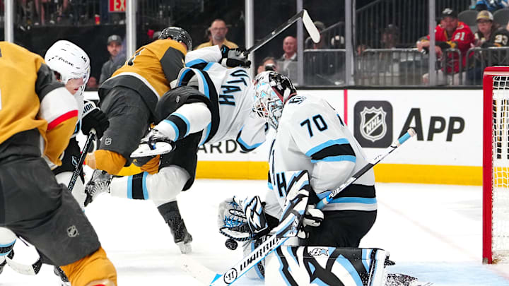 Mar 19, 2026; Las Vegas, Nevada, USA; Utah Mammoth goaltender Karel Vejmelka (70) makes a save as Vegas Golden Knights center Brett Howden (21) checks defenseman Nate Schmidt (88) during the second period at T-Mobile Arena. Mandatory Credit: Stephen R. Sylvanie-Imagn Images