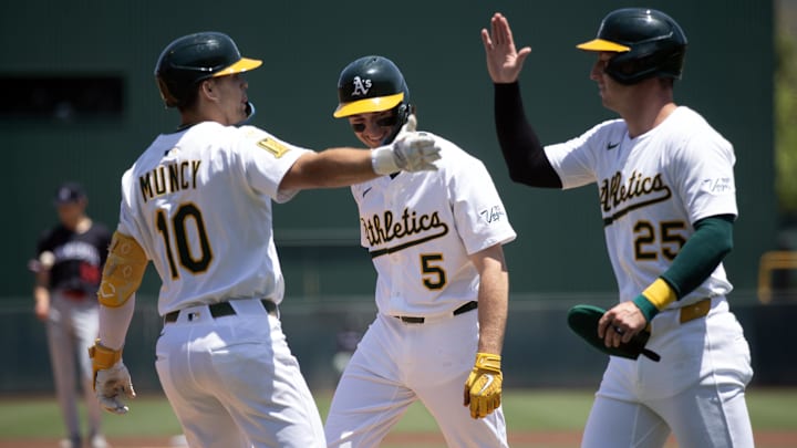 Jun 5, 2025; West Sacramento, California, USA; Athletics third baseman Max Muncy (10) is greeted by his teammates Jacob Wilson (5) and Brent Rooker (25) after hitting a three-run home run against the Minnesota Twins during the first inning at Sutter Health Park. Mandatory Credit: D. Ross Cameron-Imagn Images