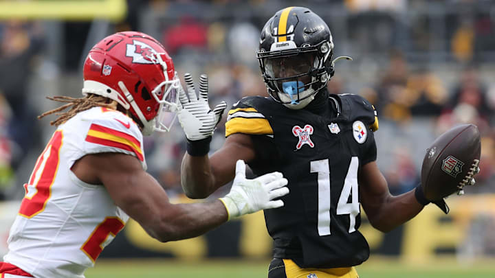Dec 25, 2024; Pittsburgh, Pennsylvania, USA;  Pittsburgh Steelers wide receiver George Pickens (14) runs after a catch as Kansas City Chiefs safety Justin Reid (20) defends during the fourth quarter  at Acrisure Stadium. Mandatory Credit: Charles LeClaire-Imagn Images