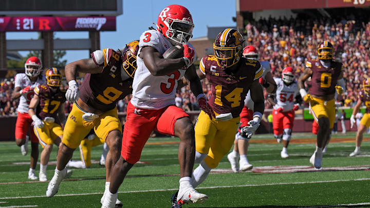 Sep 27, 2025; Minneapolis, Minnesota, USA;  Rutgers Scarlet Knights running back Antwan Raymond (3) runs with the ball as Minnesota Golden Gophers linebacker Devon Williams (9) and defensive back Kerry Brown (14) give chase during the fourth quarter at Huntington Bank Stadium.